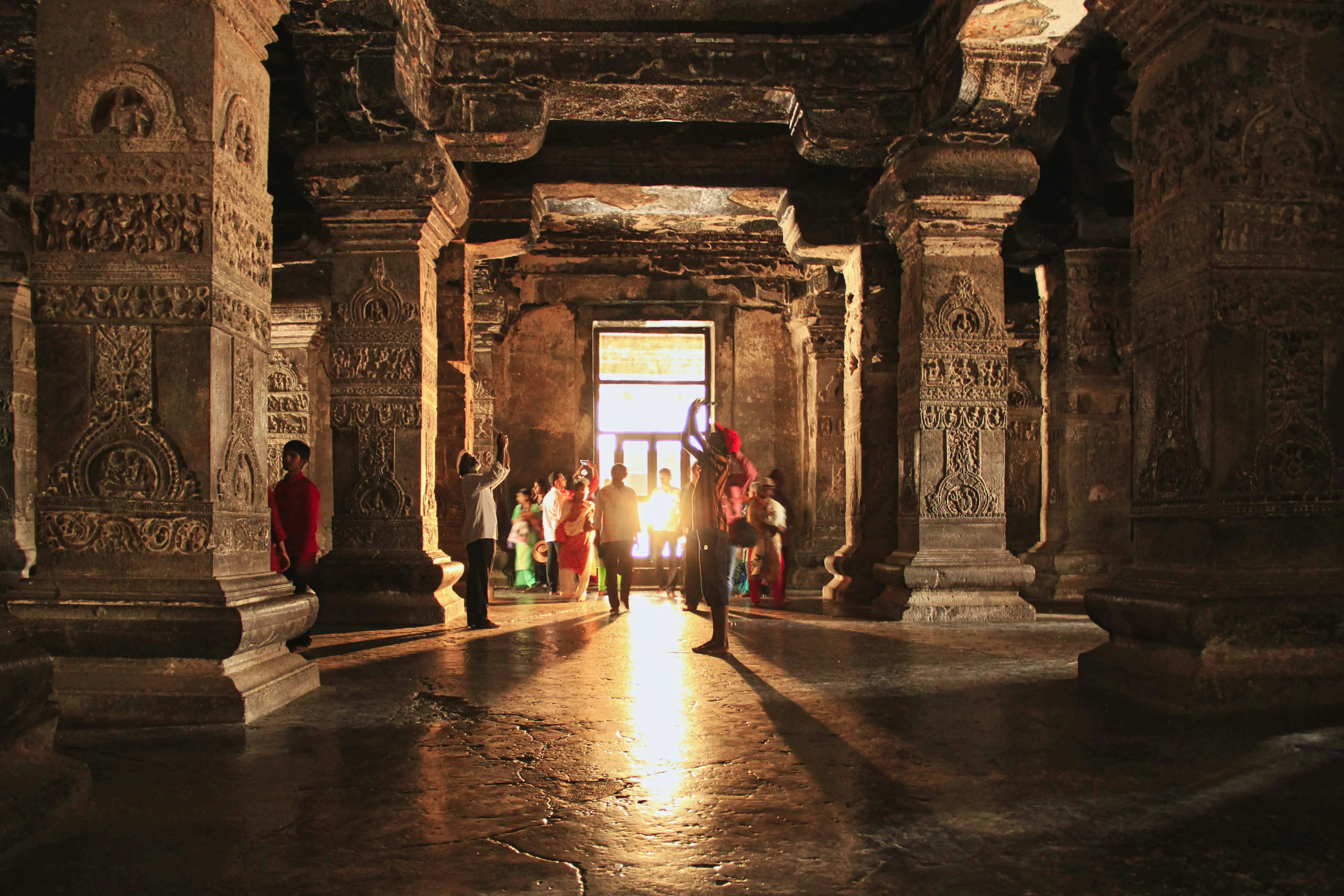 Sunlit pillared hall of a rock-cut temple