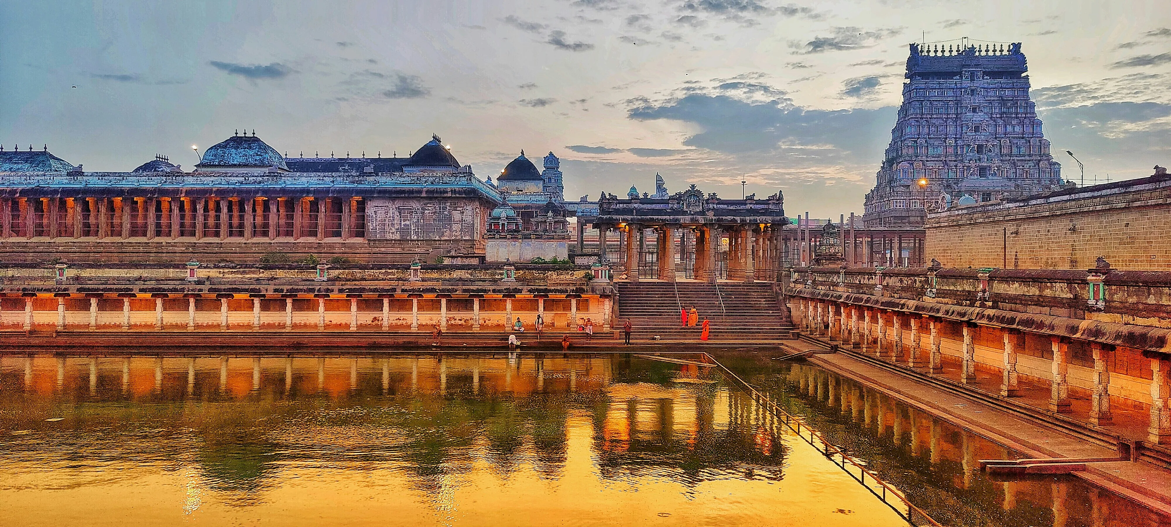South Indian temple tank and gopuram at dusk