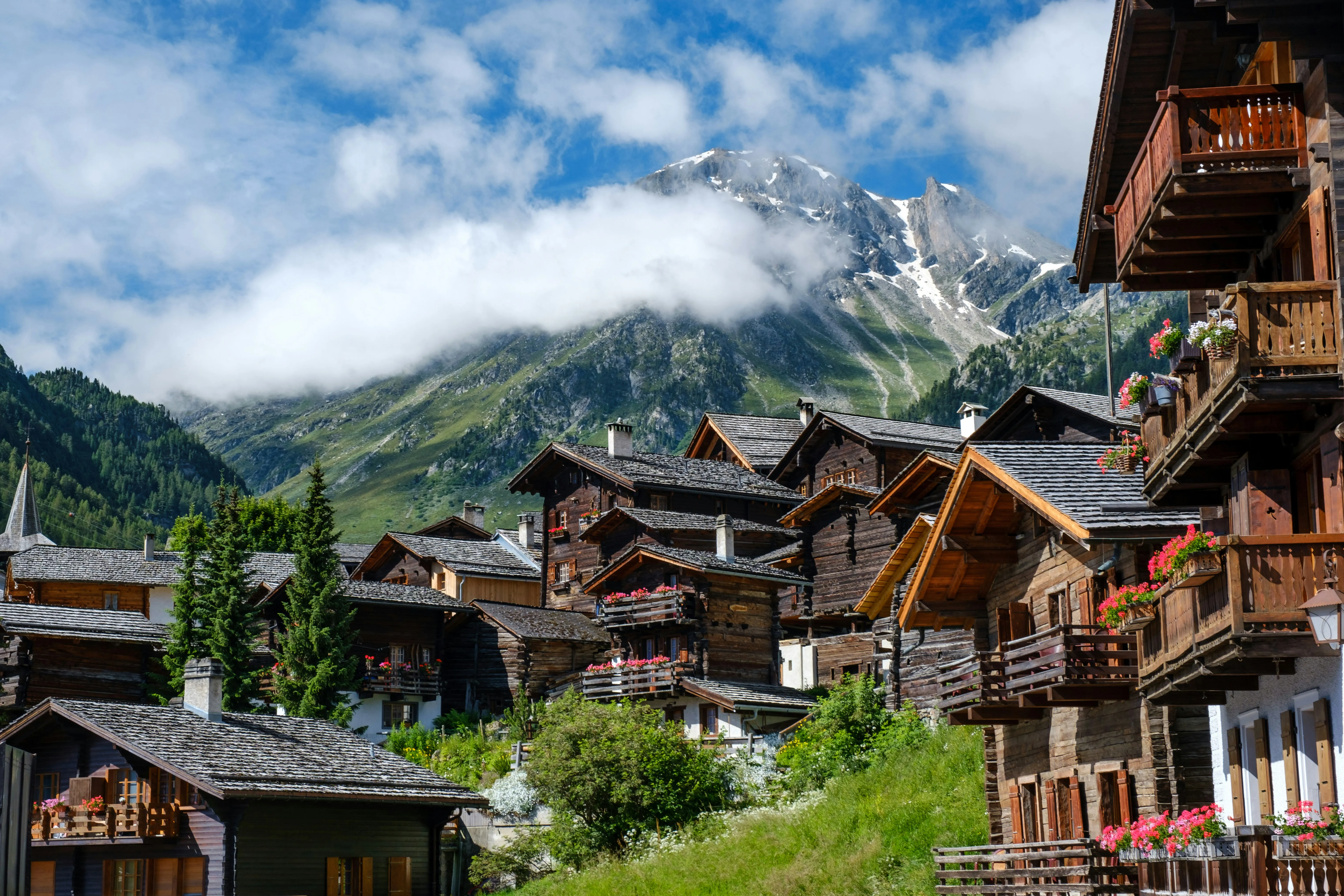Wooden chalets beneath a Swiss alpine peak